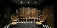 Elegant lounge ideal for a destination wedding, featuring Secrets Tides chairs, marble floors, and wood walls.