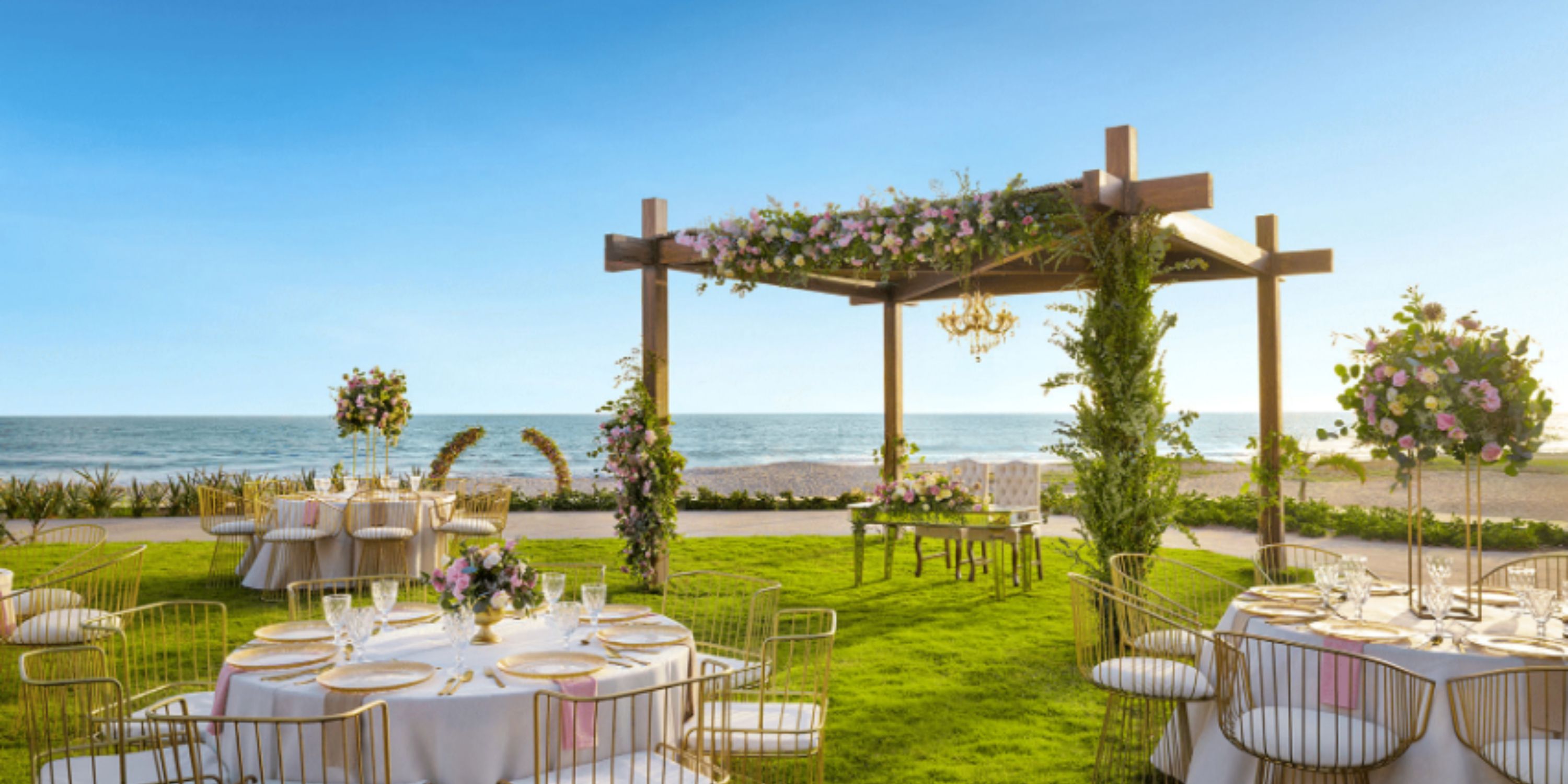 Destination wedding at Dreams Estrella del Mar Mazatlan, featuring seaside flowers under blue skies.