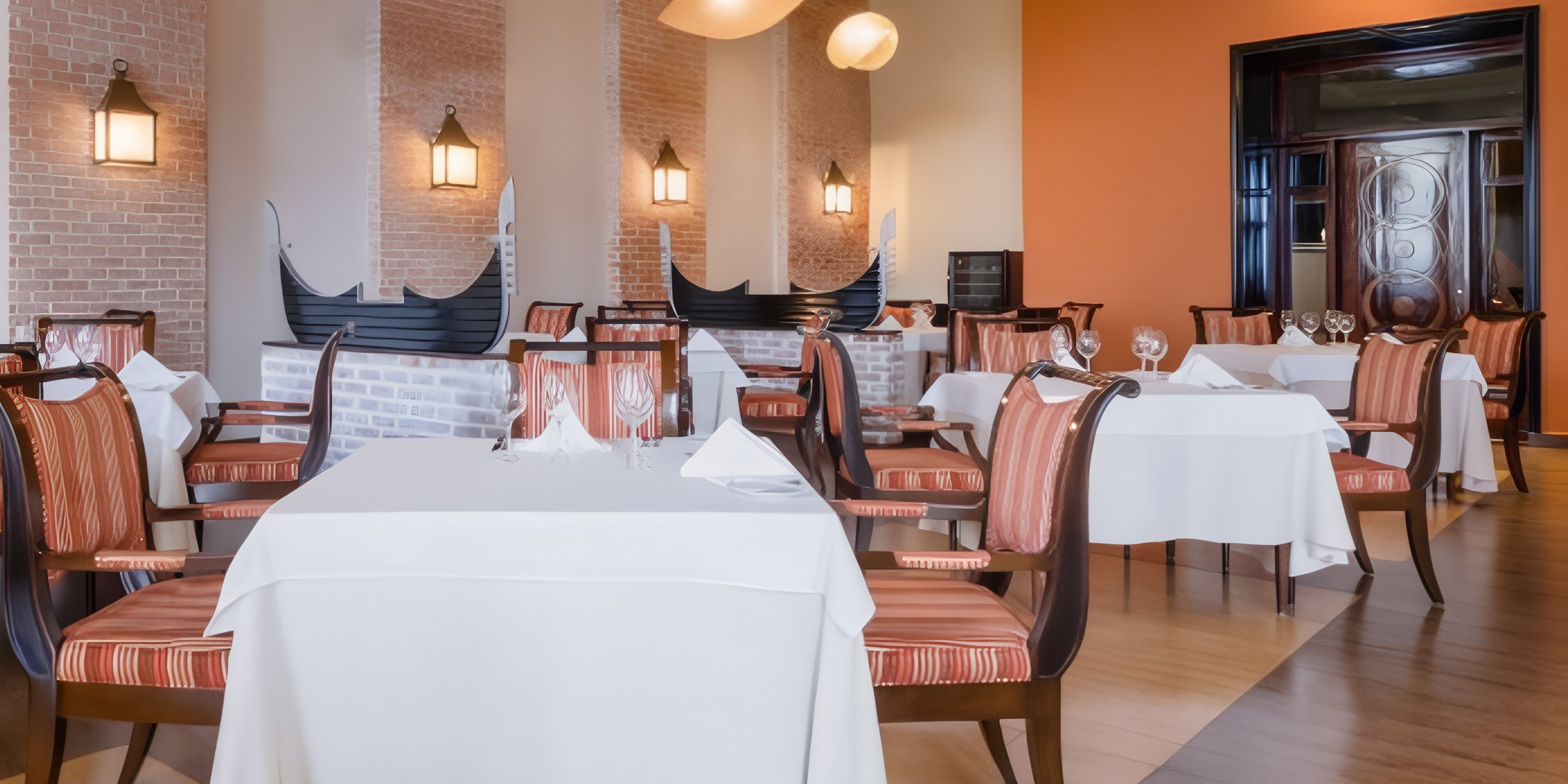 JOIA Rose Hall by Iberostar offers a stylish dining space ideal for destination weddings, with striped chairs and brick accents.