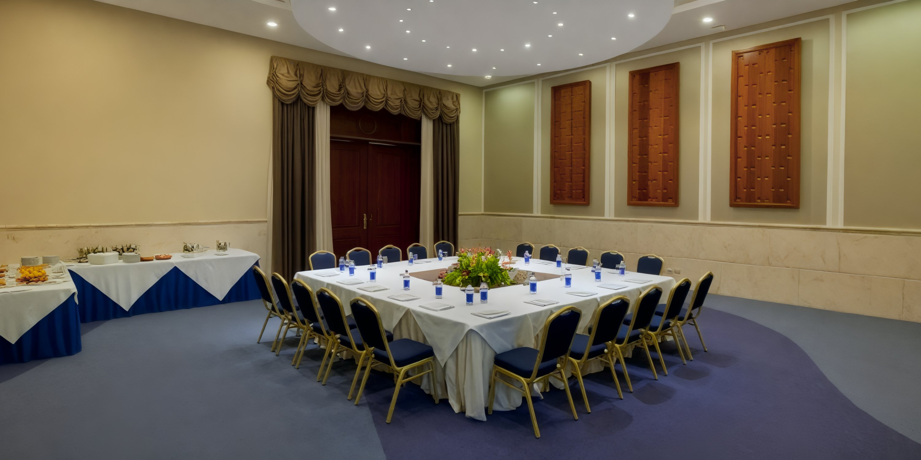 JOIA Bavaro by Iberostar: Experience an elegant U-shaped table arrangement with chairs, adorned with beautiful centerpieces perfect for your destination wedding.