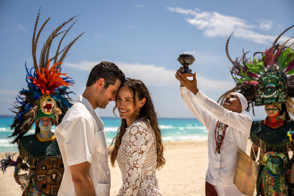 A smiling couple enjoys their destination wedding on the beach, highlighting the Riviera Maya wedding experience and its unique value.