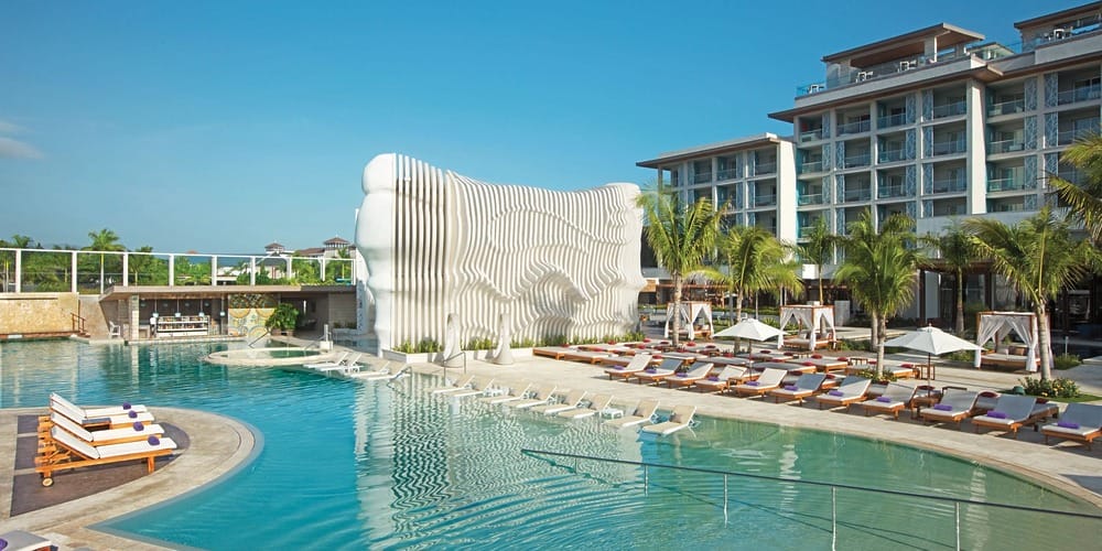 Modern resort with large pool and cabanas; perfect for destination wedding packages in Jamaica under $3000.