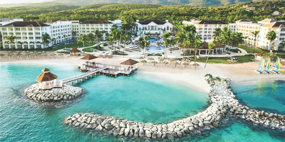 Aerial shot of a resort with pools and palms, perfect for destination weddings in Jamaica under $3,000.