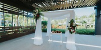 Destination wedding altar at Lopesan Costa Bavaro, adorned with white drapes and floral decorations.