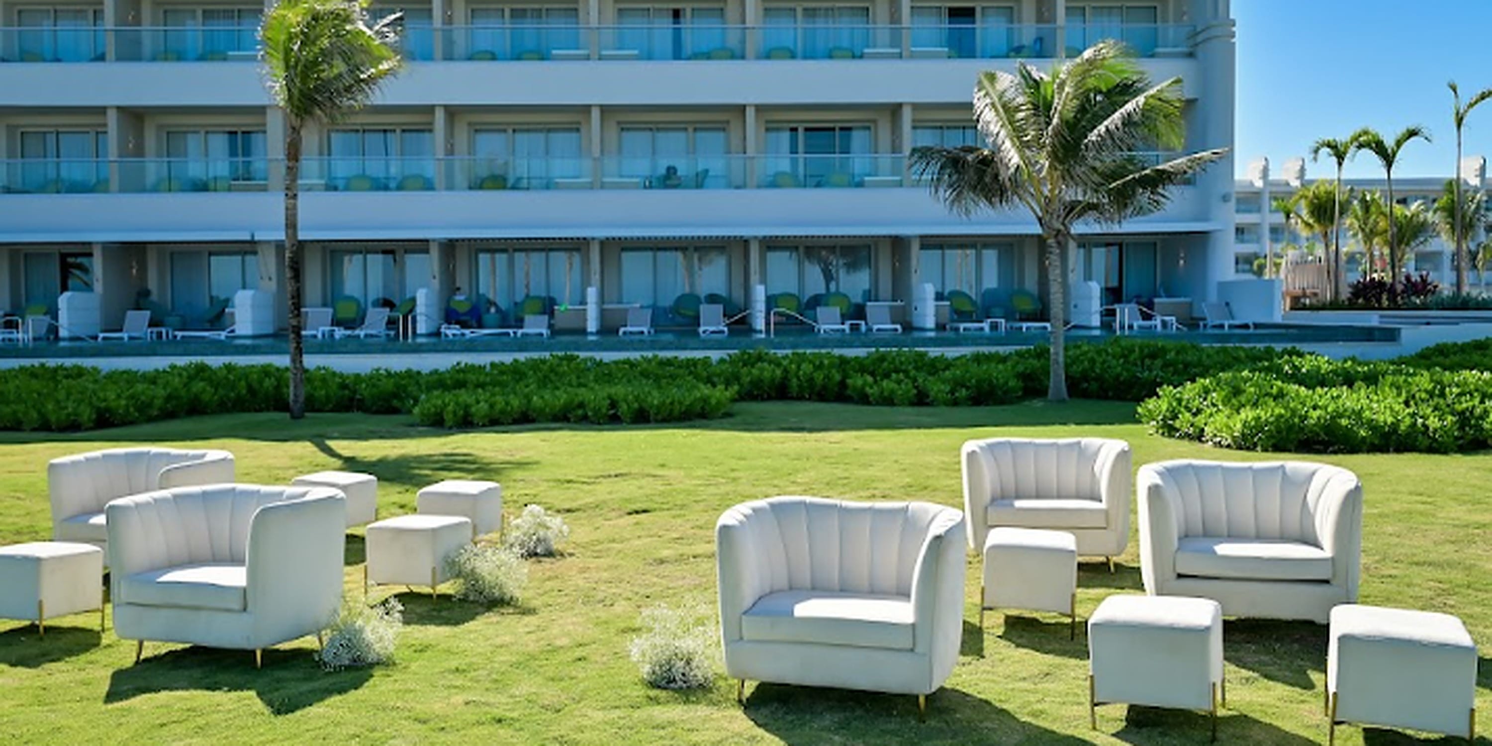 Destination wedding seating on a lawn in front of the Princess Grand Jamaica resort hotel.