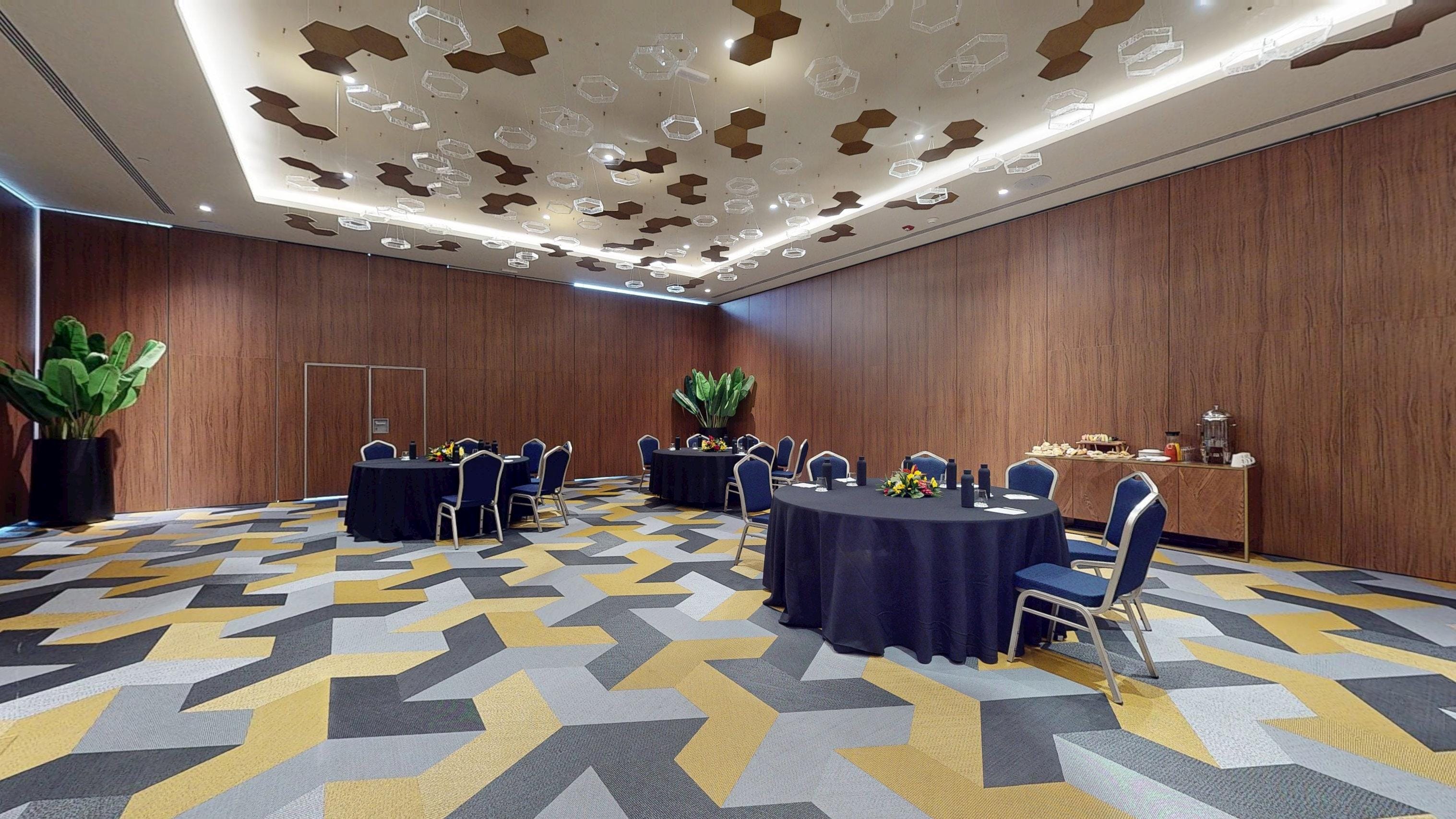 Princess Grand Jamaica banquet hall set up with navy tables for a destination wedding.