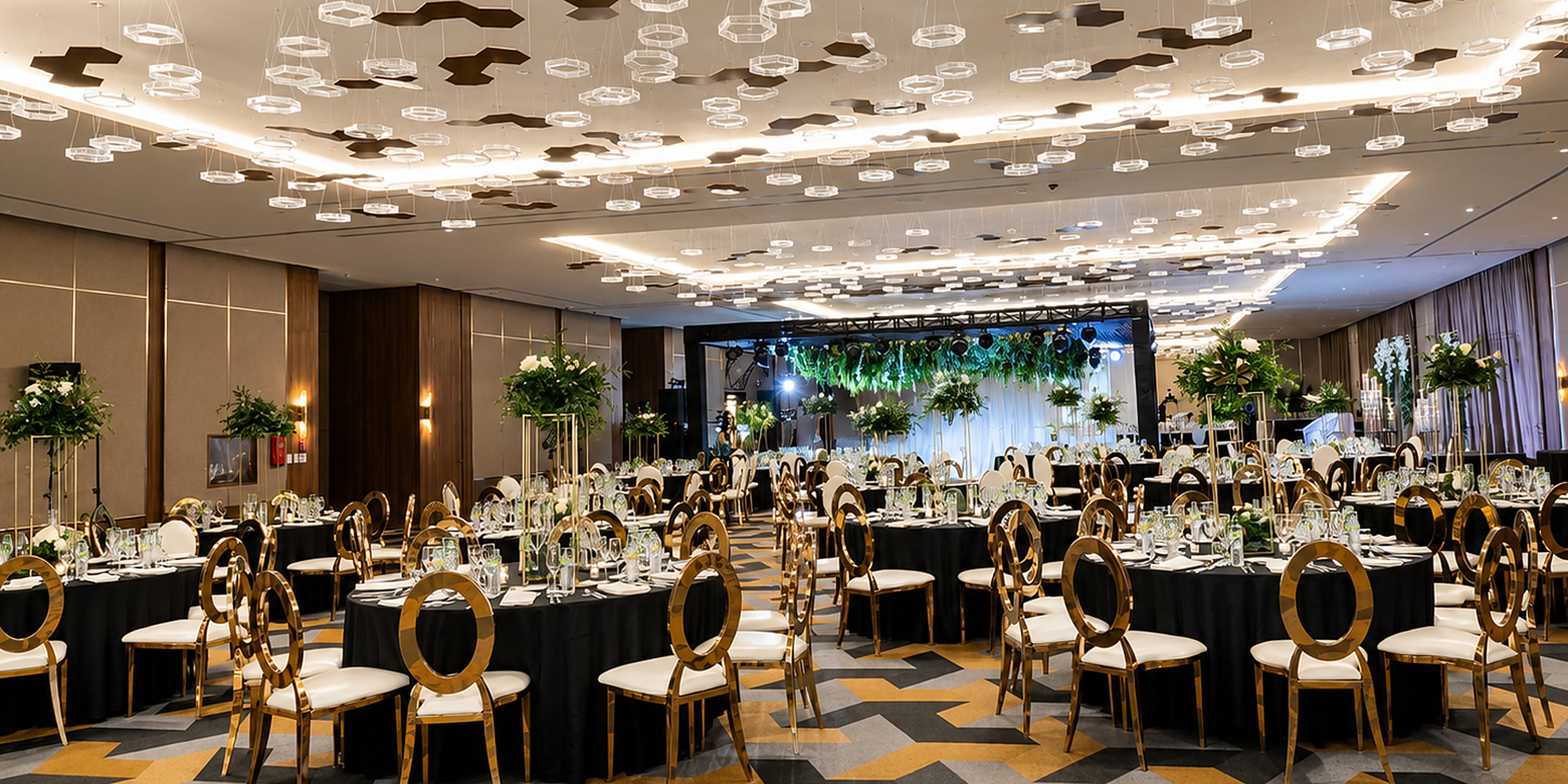 Princess Grand Jamaica wedding banquet hall with round tables, black tablecloths, and gold chairs.