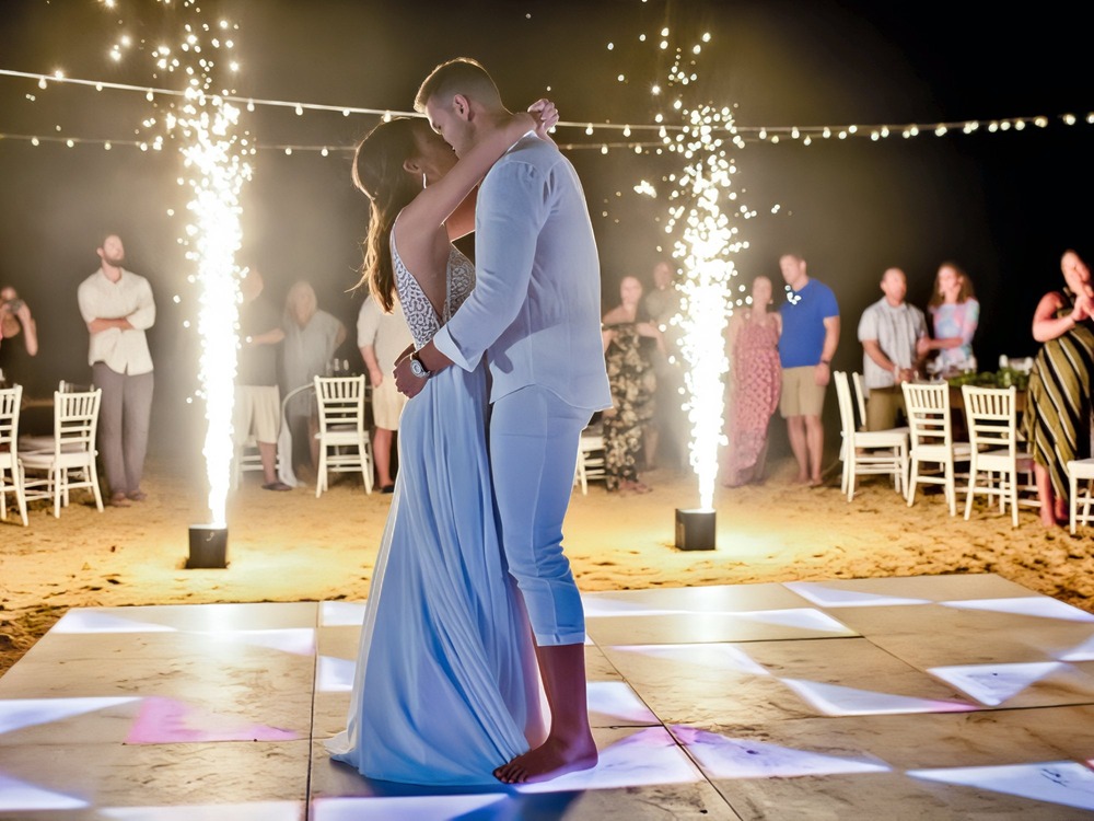 Barefoot and beaming, the couple twirls beneath a burst of fireworks, savoring every moment of their magical destination wedding celebration.