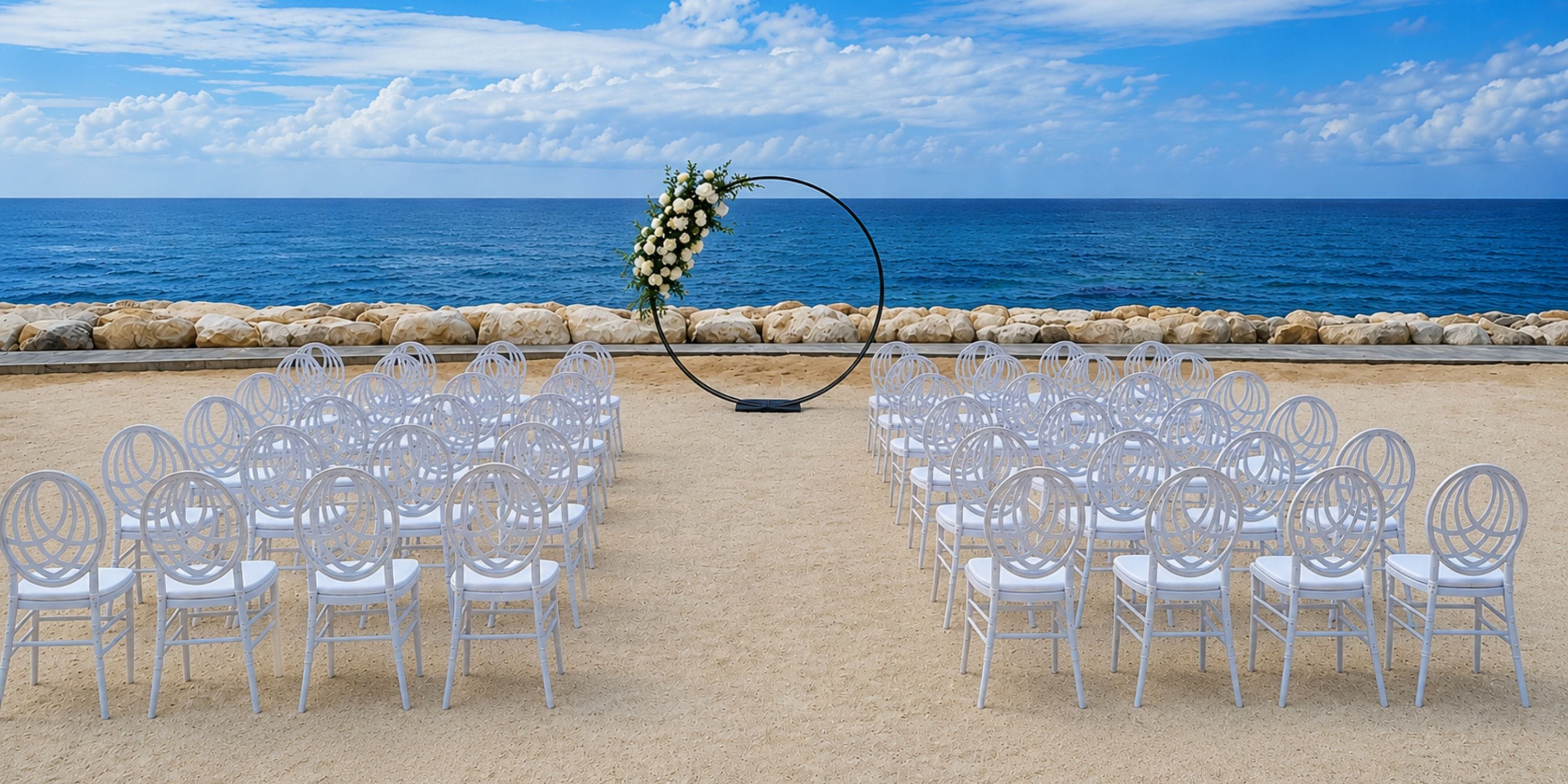 Princess Grand Jamaica: rows of white chairs set for a destination wedding by the ocean arch.