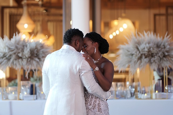 A couple shares a close dance at a destination wedding reception at Princess Grand Jamaica with elegant decor.