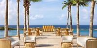 Secrets Baby Beach Aruba: Ideal for a destination wedding, with wicker lounges, pool, ocean views, palms.