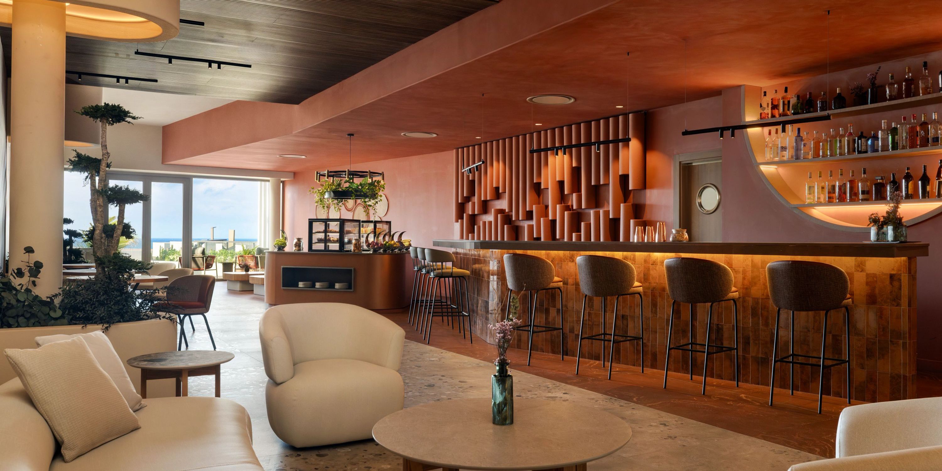 Secrets Baby Beach Aruba: Modern lounge perfect for a destination wedding, with bar, stools, and window seats.