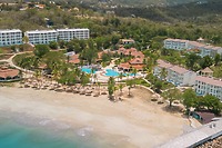 Aerial view of Secrets St Lucia resort, a dreamy destination wedding spot with pools, palms, and white buildings.