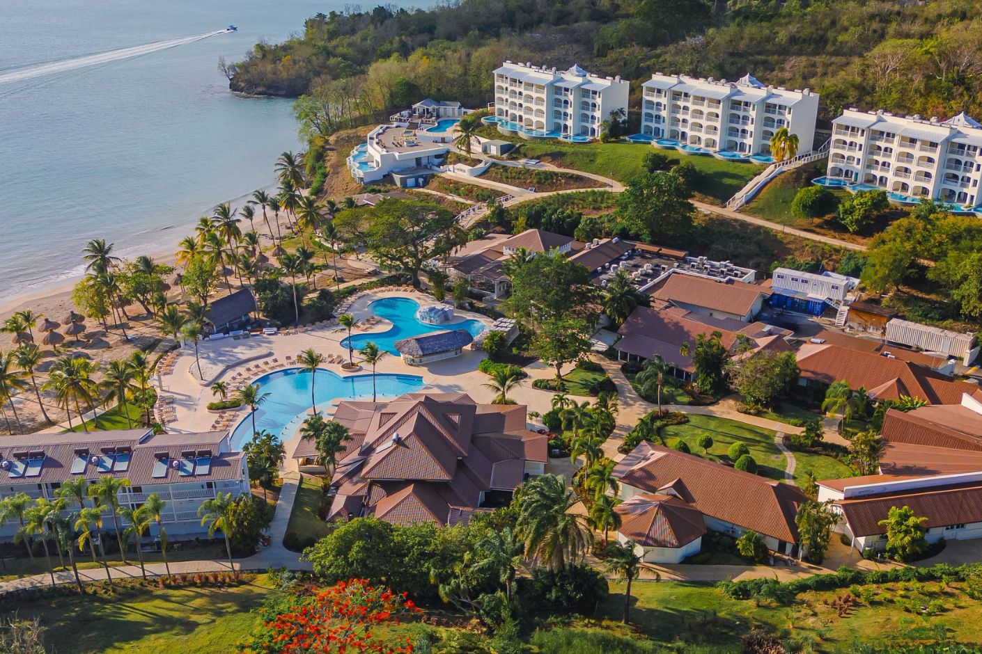Aerial view of Secrets St Lucia resort, ideal for a destination wedding with pools and palm-lined buildings.
