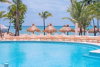 Secrets St Lucia: round pool, lounge chairs, and ocean views—perfect for a destination wedding.