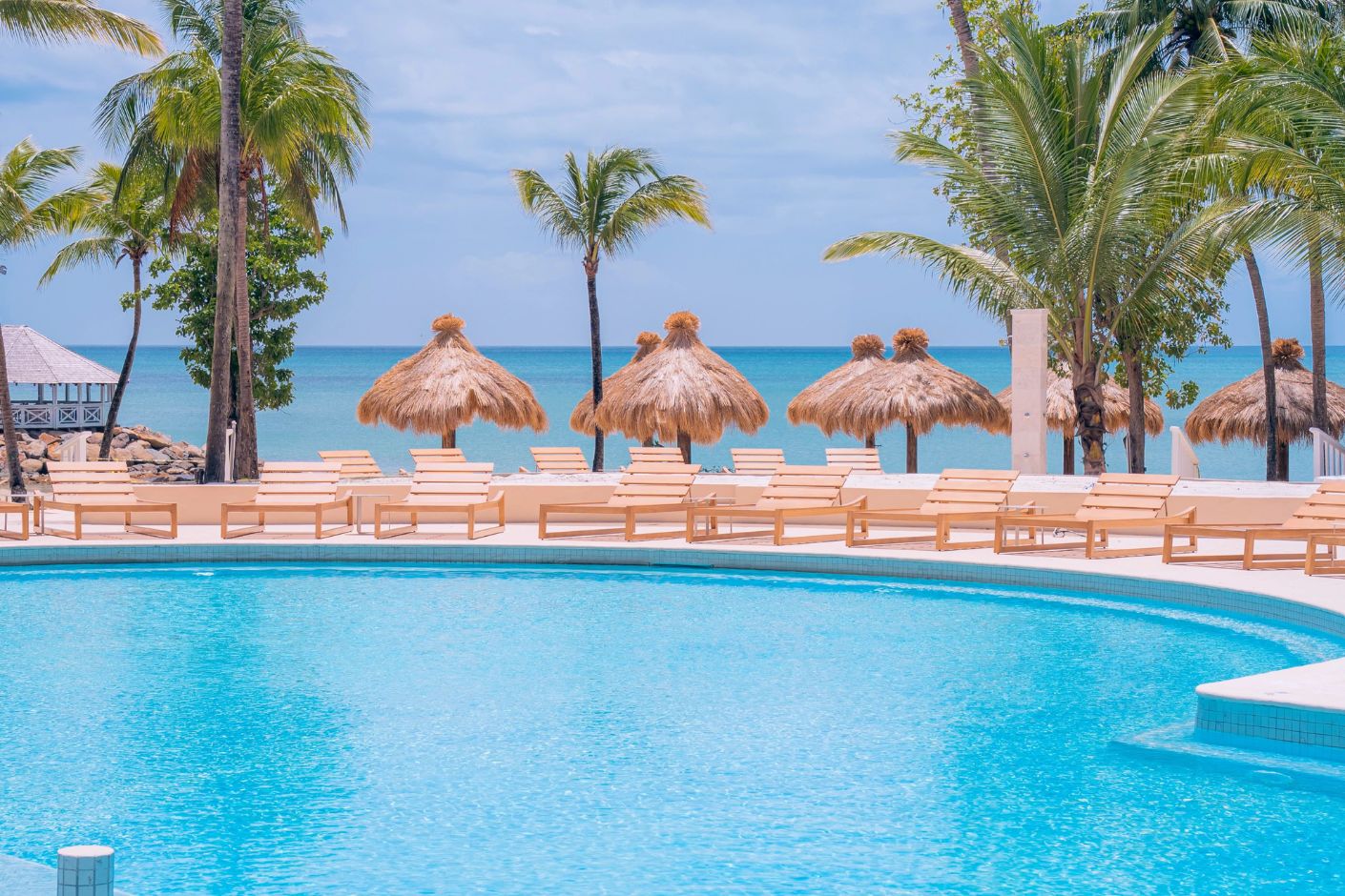 Secrets St Lucia: round pool, lounge chairs, and ocean views—perfect for a destination wedding.