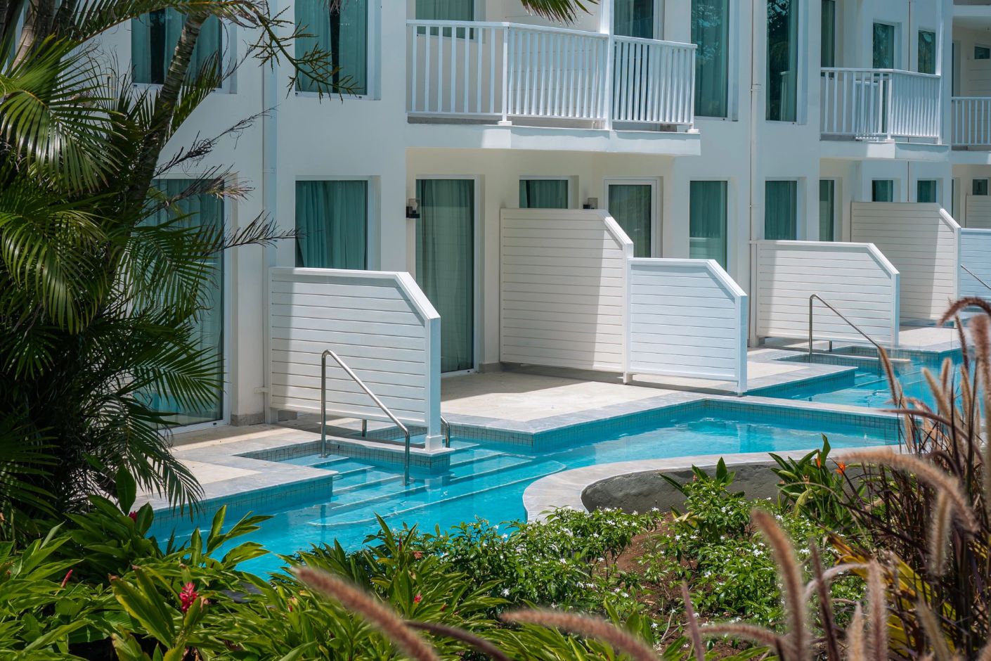 Perfect for a destination wedding, Secrets St Lucia features white rooms with balconies and lush pool views.