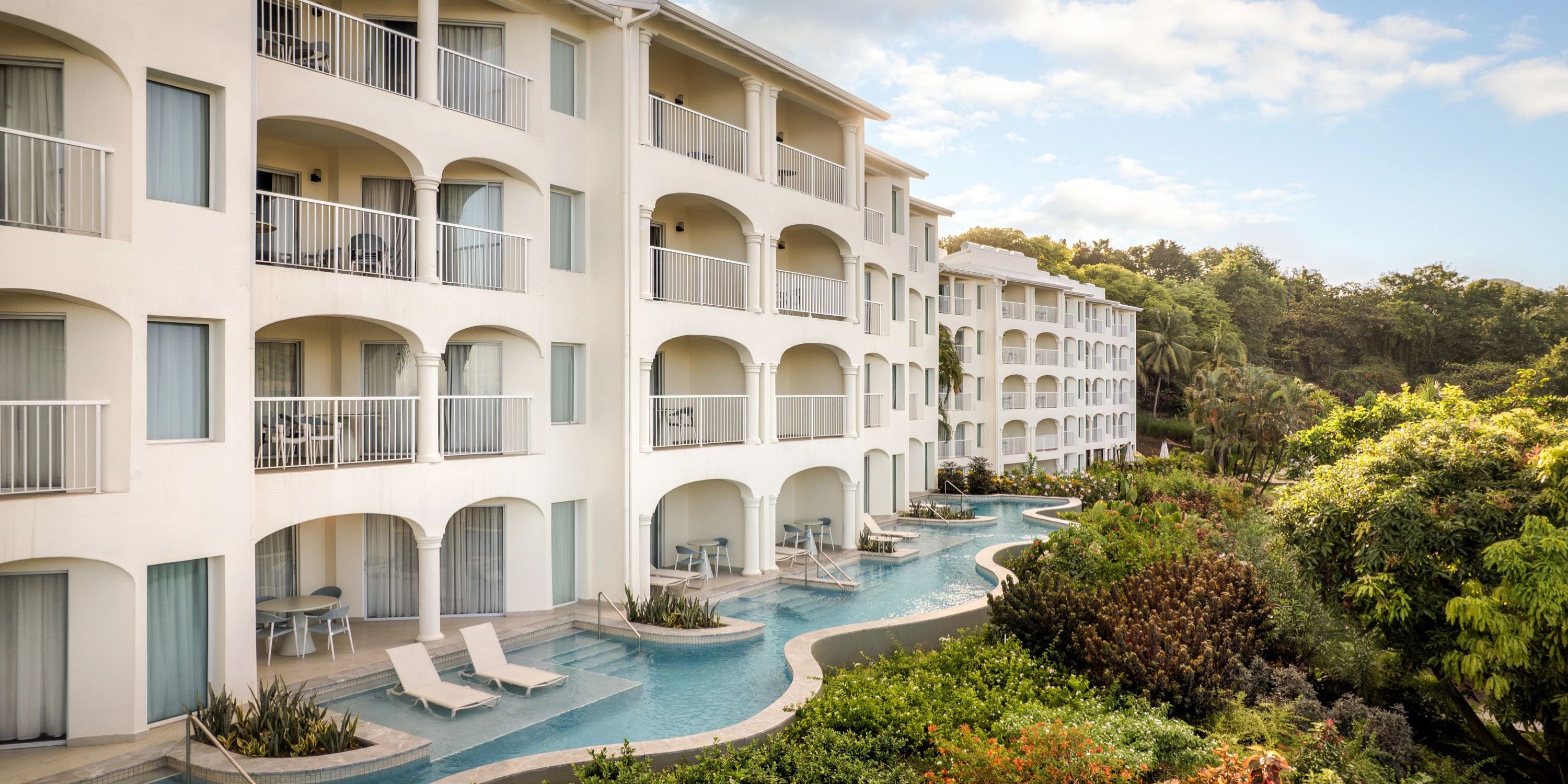 Secrets St Lucia: Elegant white resort with balconies, winding pool, gardens&mdash;ideal for a destination wedding.