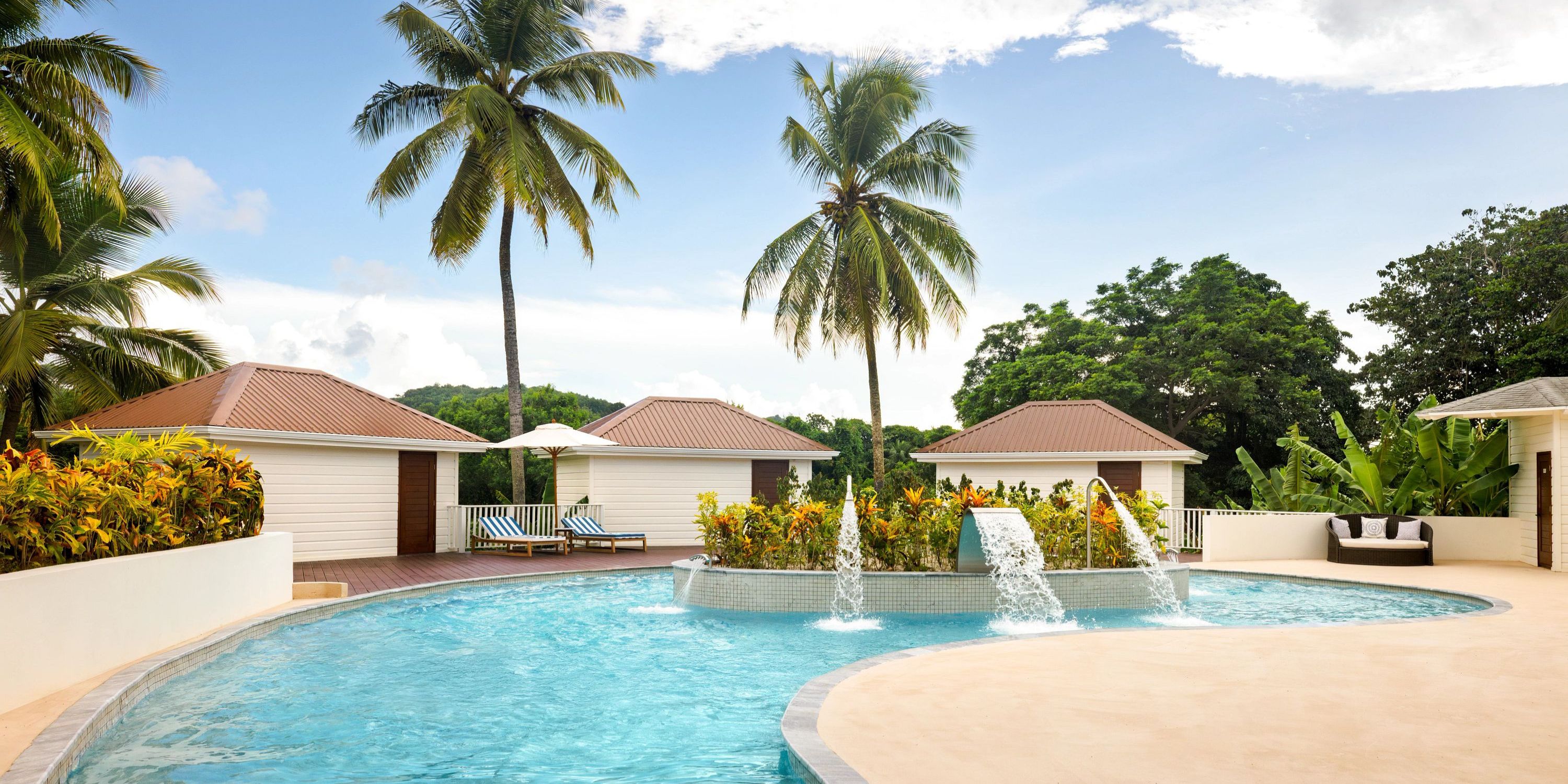Secrets St Lucia offers a picturesque outdoor pool with fountains, palm trees, and cabanas&mdash;ideal for a destination wedding.