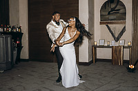 Carina and Marvin share a dance at their indoor destination wedding reception.