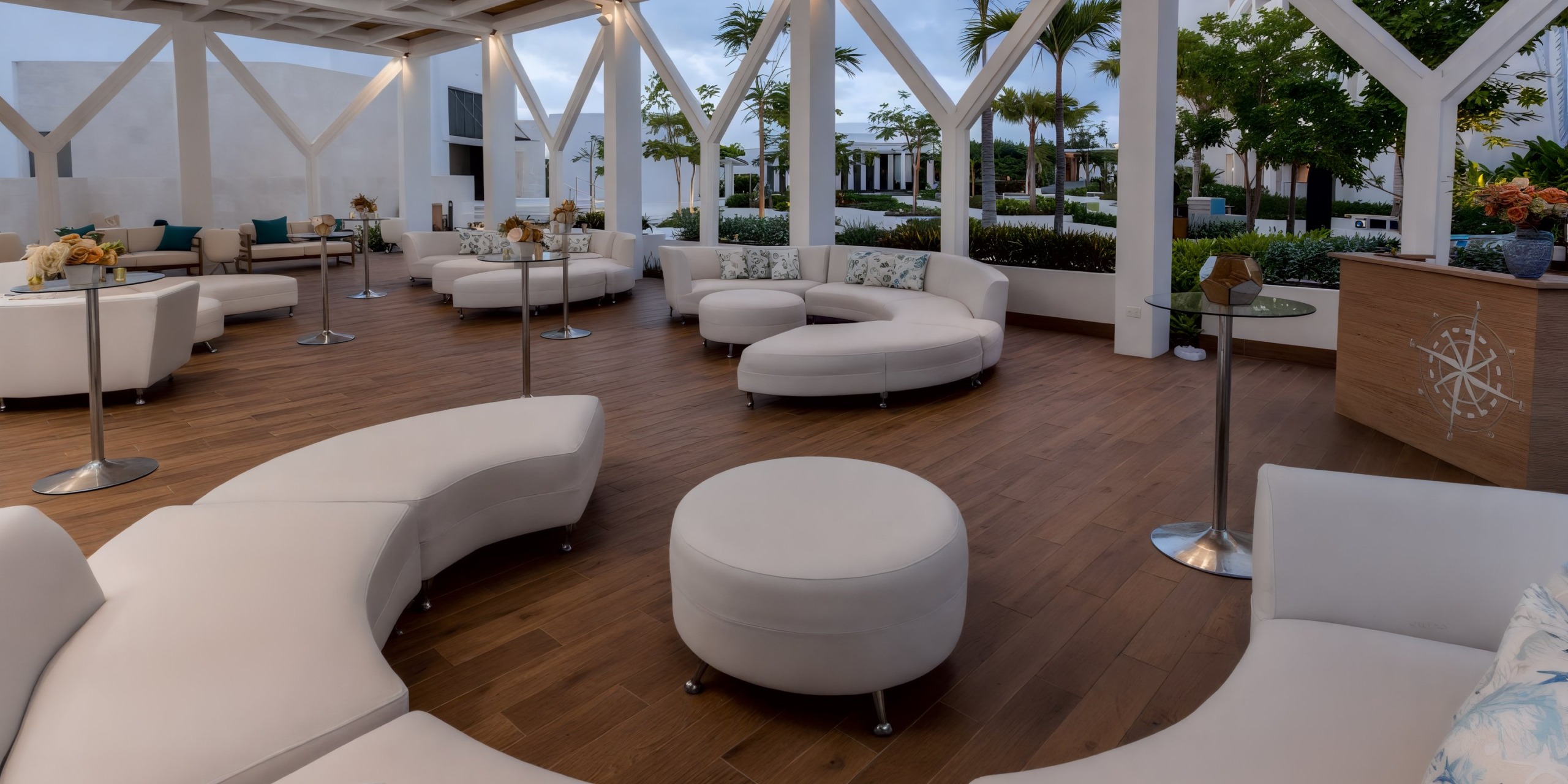 Dreams Cap Cana Resort & Spa, an ideal location for a destination wedding, boasts modern white seating and elegant wood flooring.