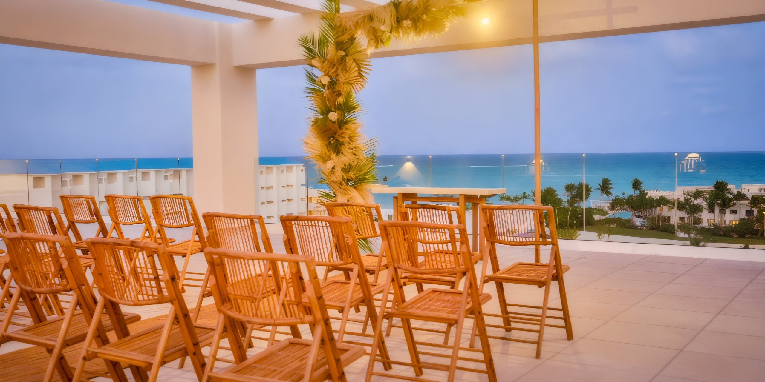 Dreams Cap Cana offers breathtaking ocean views with wooden chairs and tropical decor, making it an ideal setting for a destination wedding.