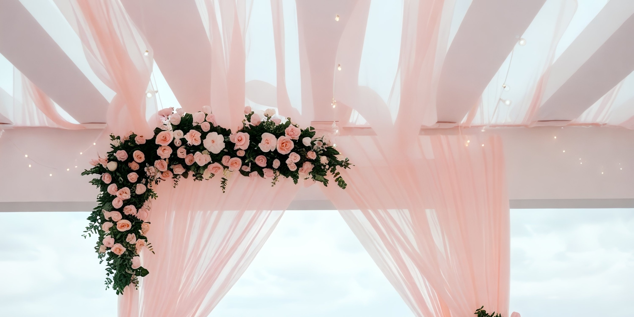 Pink drapes and floral decorations beautifully adorned the wedding arch at Dreams Cap Cana Resort & Spa, creating an enchanting setting for a destination wedding.