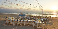 Destination wedding setup at UNICO 20&deg;105&deg; Riviera Nayarit with decorated tables and glowing string lights.