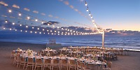 UNICO 20&deg;105&deg; Riviera Nayarit destination wedding beachside dining with string lights at sunset.