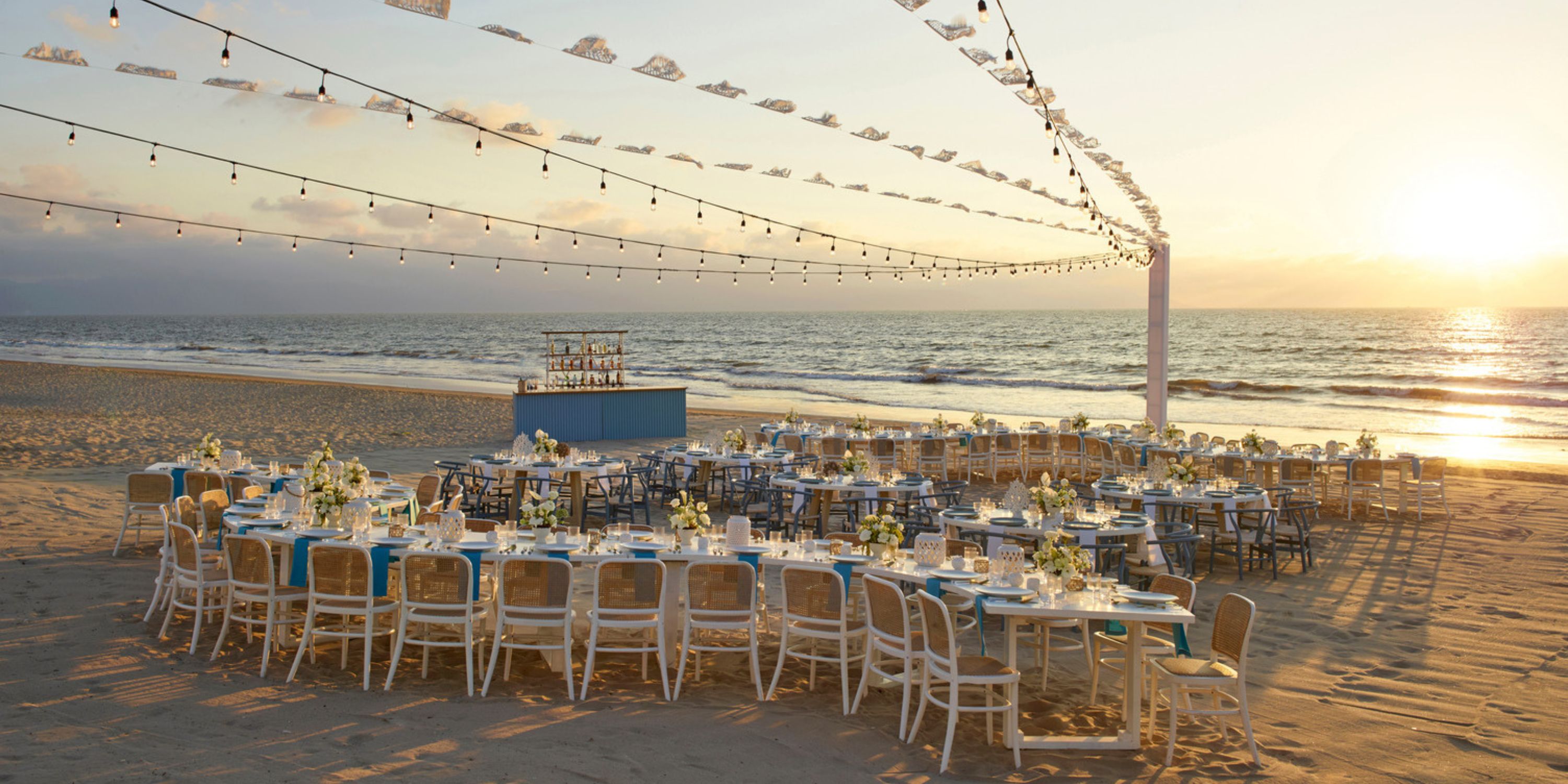Destination wedding setup at UNICO 20°105° Riviera Nayarit with decorated tables and glowing string lights.