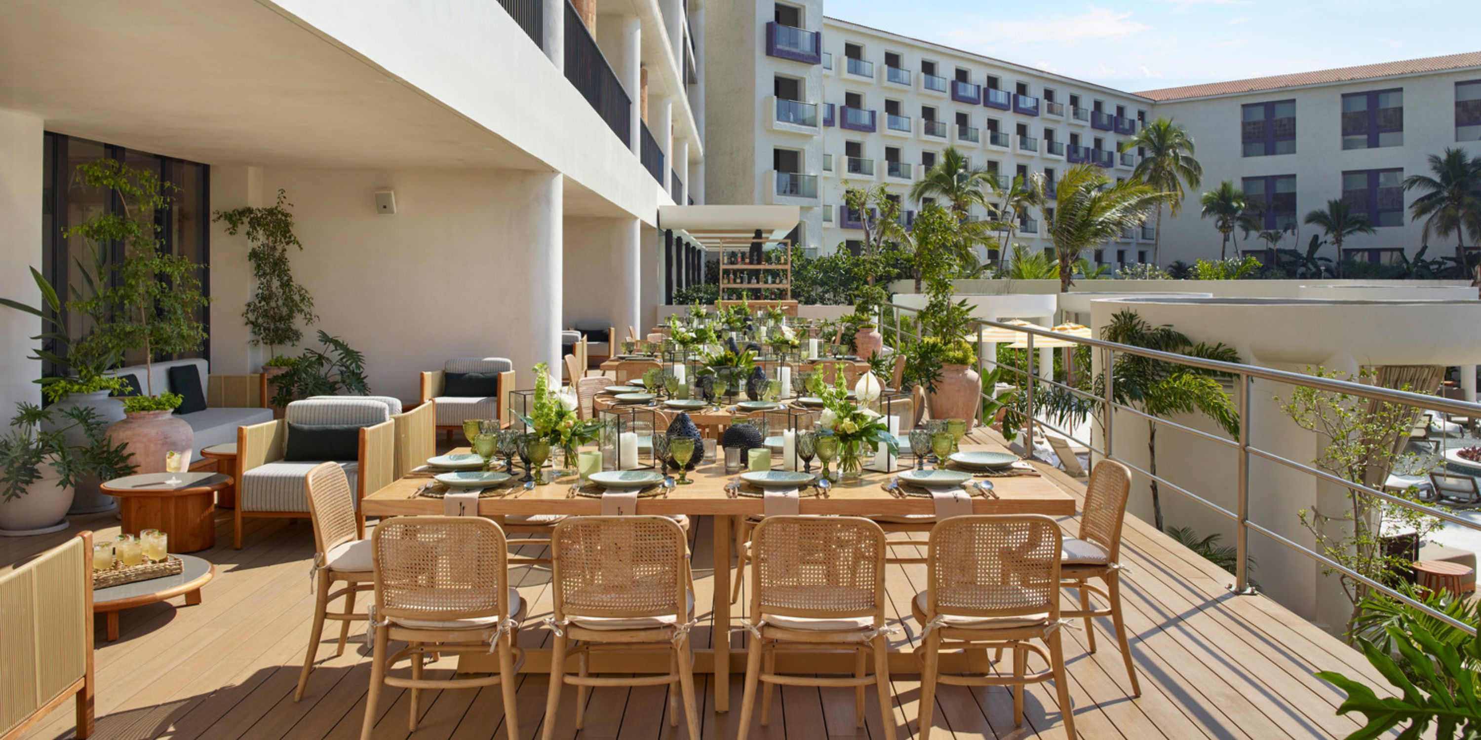 Outdoor dining at UNICO 20&deg;105&deg; Riviera Nayarit, ideal for a destination wedding, with wooden tables and lush greenery.