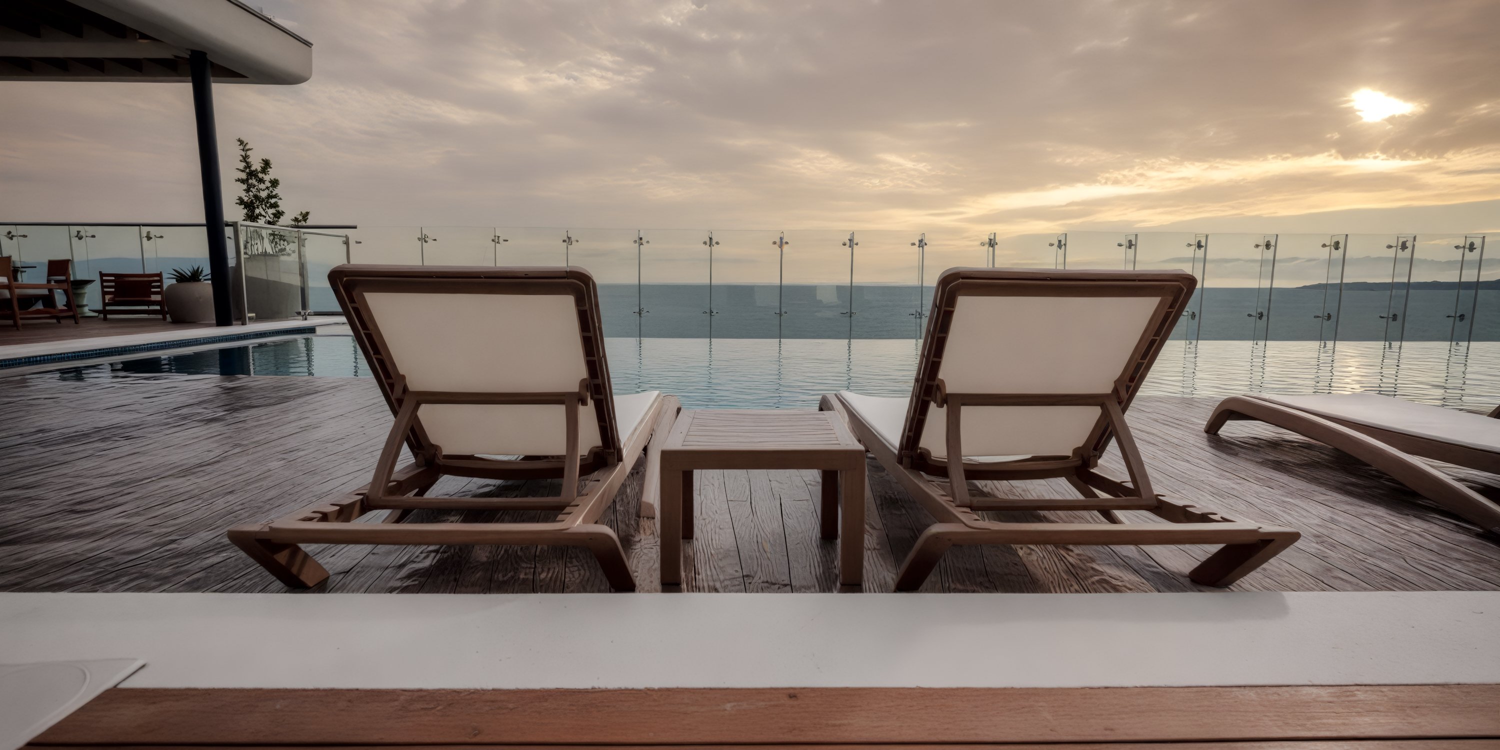 Two lounge chairs at UNICO 20°105° Riviera Nayarit, a dreamy destination wedding spot, face the sunset.