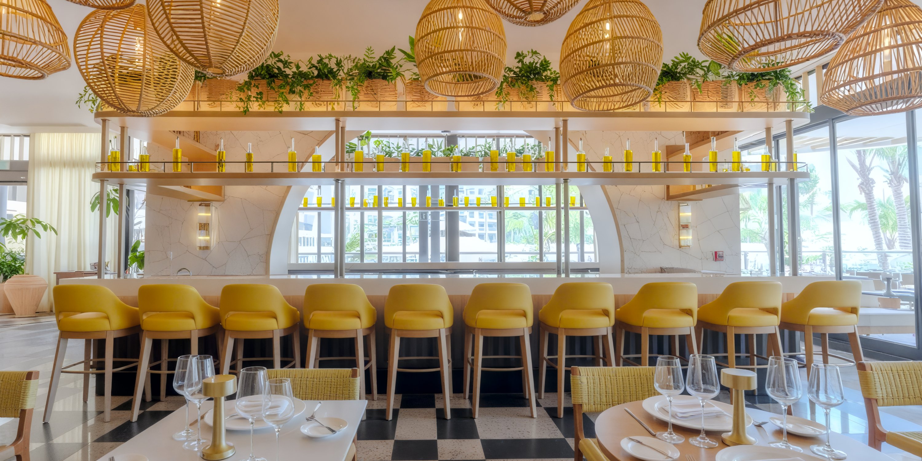 UNICO 20°105° Riviera Nayarit bar—perfect for a destination wedding—with yellow chairs and plants.