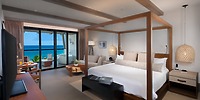 Experience a wedding getaway in an ocean-view room at UNICO 20°87°, featuring a private balcony and luxurious four-poster bed, perfect for an unforgettable destination wedding.
