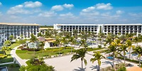 UNICO 20°87° Resort: surrounded by swaying palm trees and a collection of elegant buildings beneath a clear blue sky, it's the ideal setting for a destination wedding.