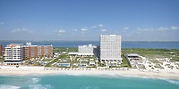 Hotel Riu Ventura: an ideal destination wedding venue featuring a beachfront complex with pools, elegant lounge areas, and multiple buildings to accommodate your guests.
