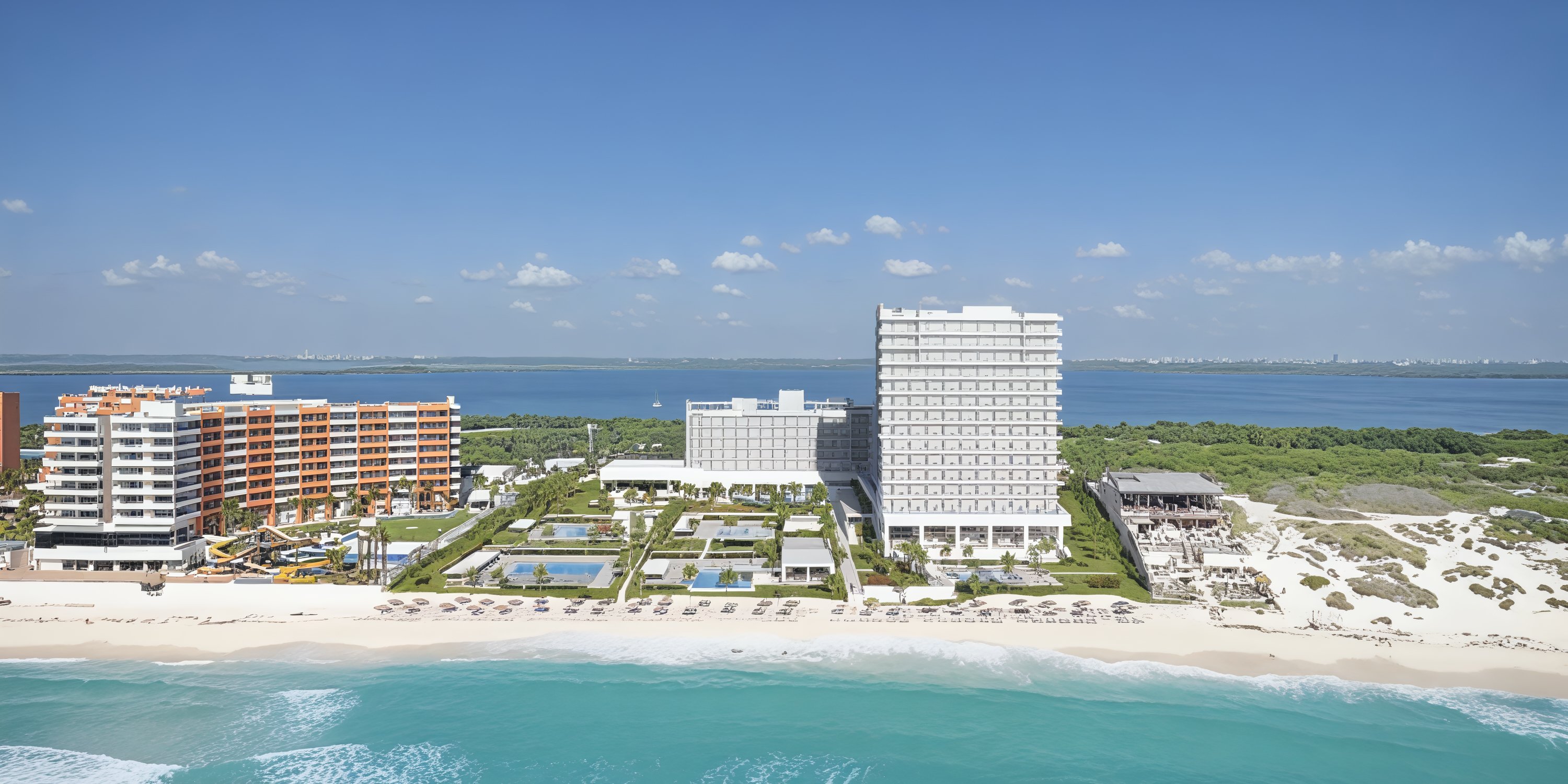 Hotel Riu Ventura: an ideal destination wedding venue featuring a beachfront complex with pools, elegant lounge areas, and multiple buildings to accommodate your guests.