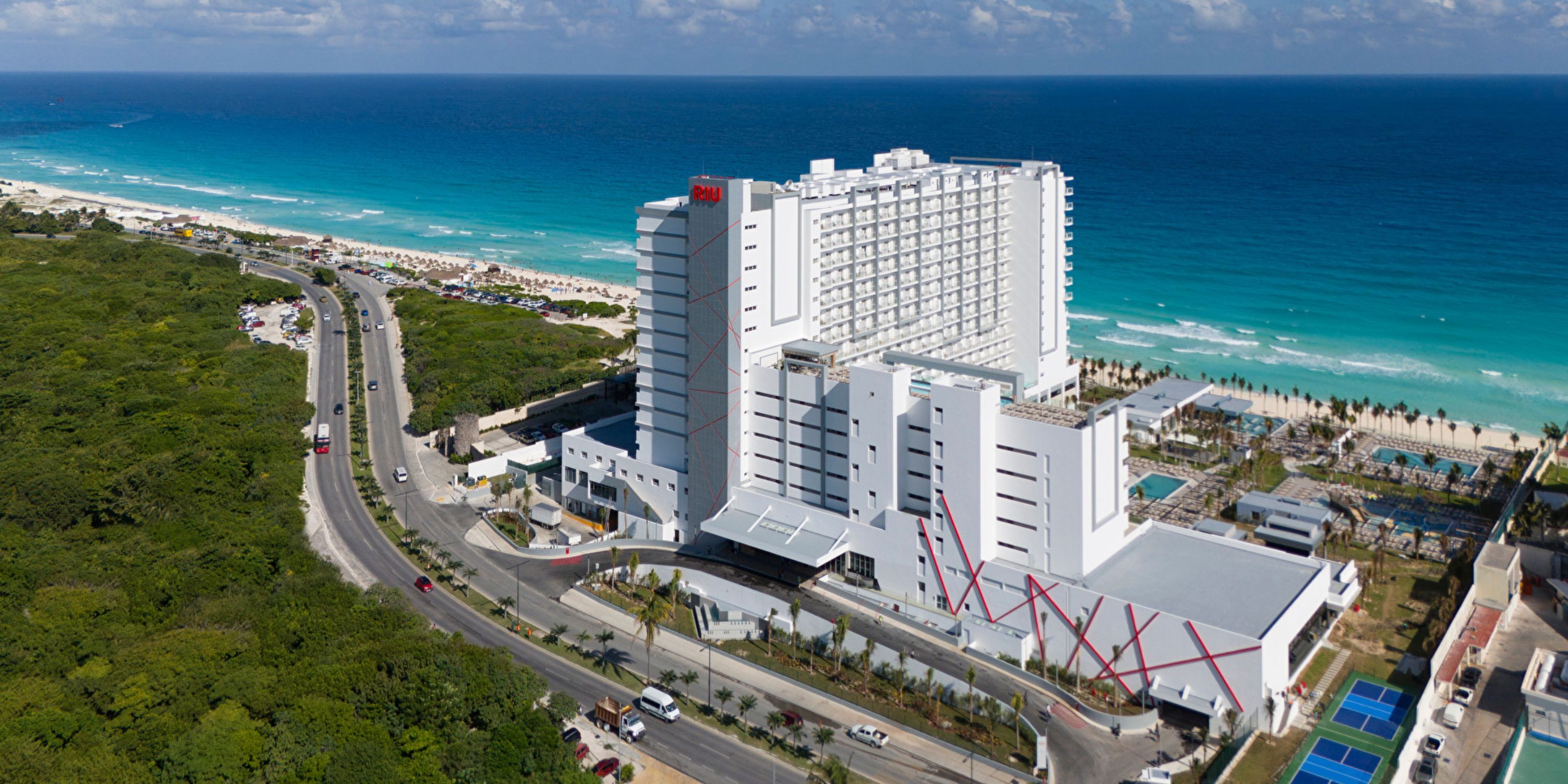 Aerial view of Hotel Riu Ventura, an ideal destination wedding spot with ocean and road in the background.