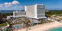 Hotel Riu Ventura: ideal beachfront resort for destination weddings with pools, palm trees, and ocean views.