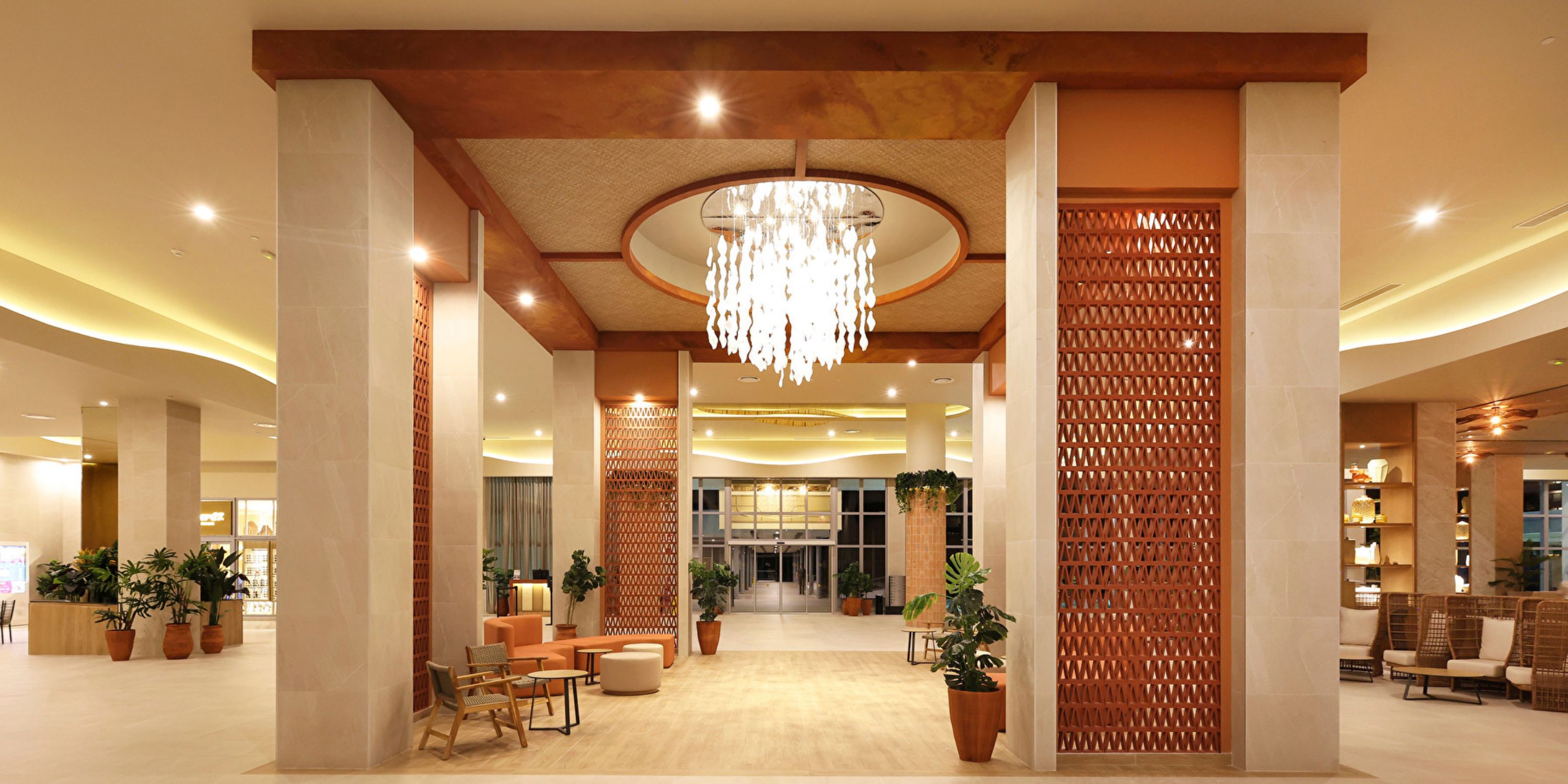 Hotel Riu Ventura lobby, ideal for a destination wedding, featuring chandelier, seating, and pillars.