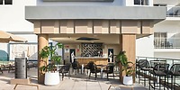 Hotel Riu Ventura's outdoor bar, ideal for destination weddings, has black chairs and potted plants.