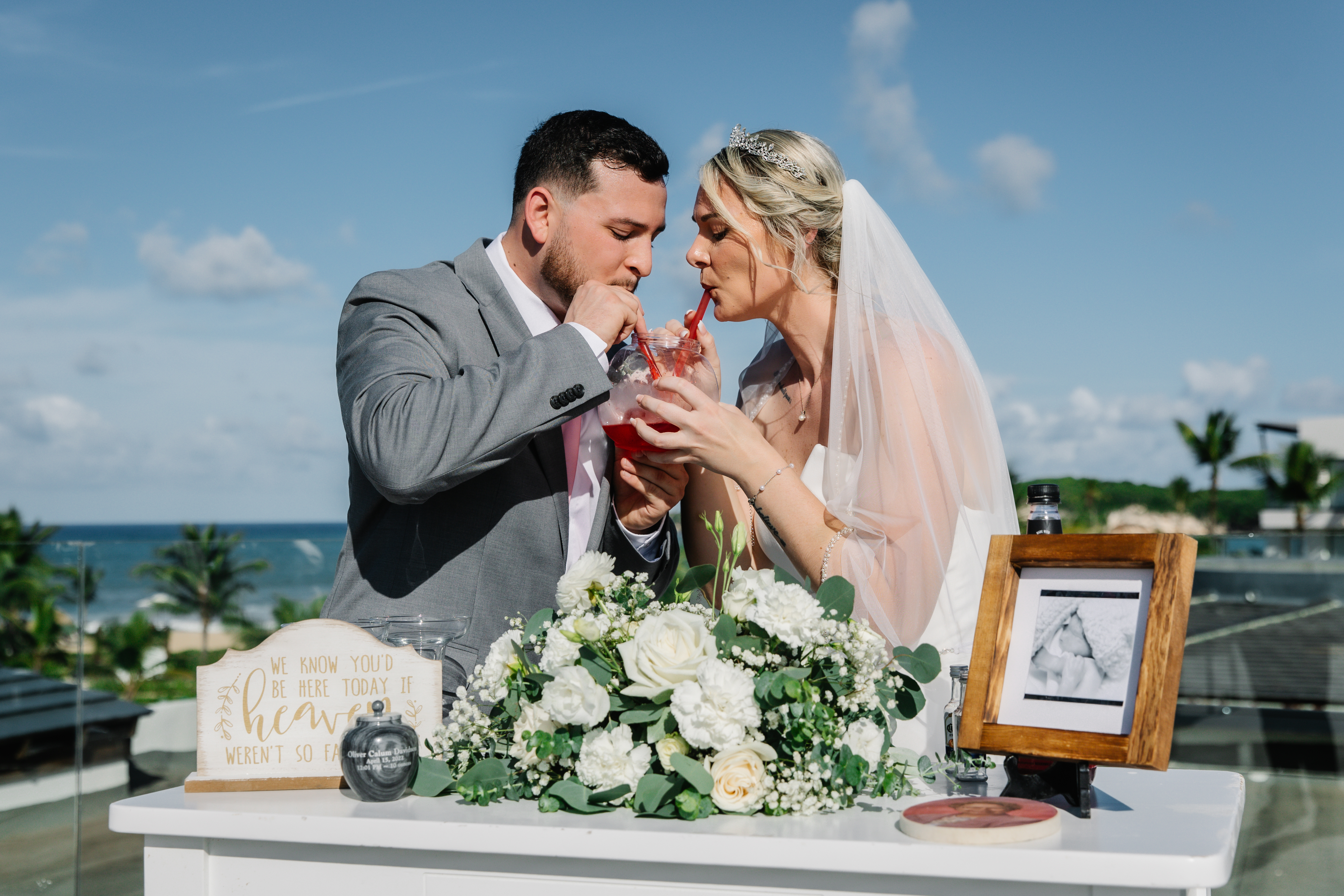Carina and Steven share a toast at their romantic destination wedding by the ocean.