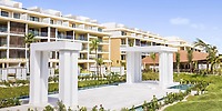 Modern resort with balconies and a white pergola, perfect for destination weddings at Majestic Mirage Costa Mujeres.