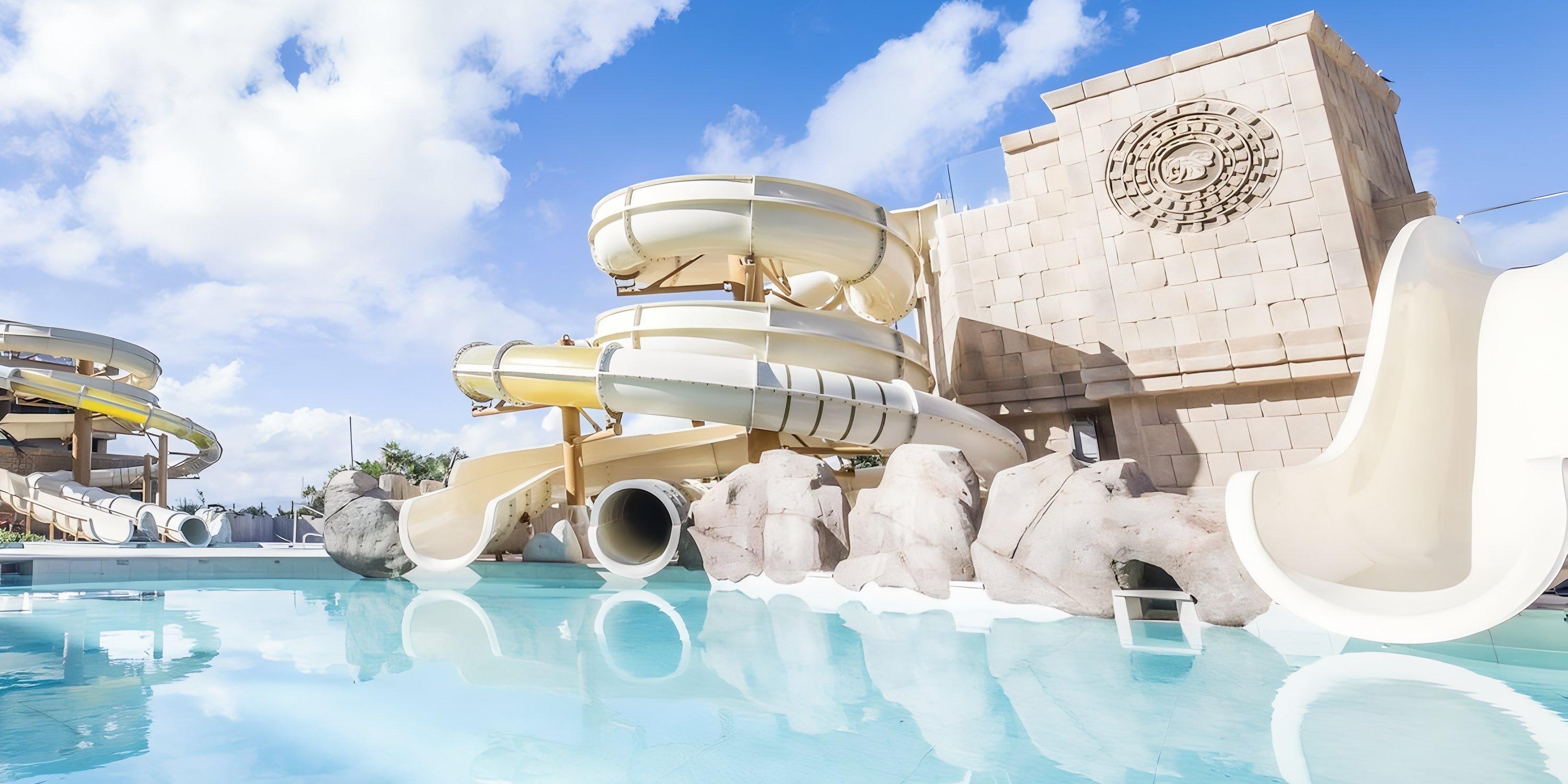 Spiral water slides and a stone structure at Majestic Mirage Costa Mujeres, an ideal wedding venue.
