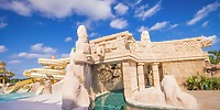 Outdoor water slide beside majestic temple at Majestic Mirage Costa Mujeres destination wedding venue.