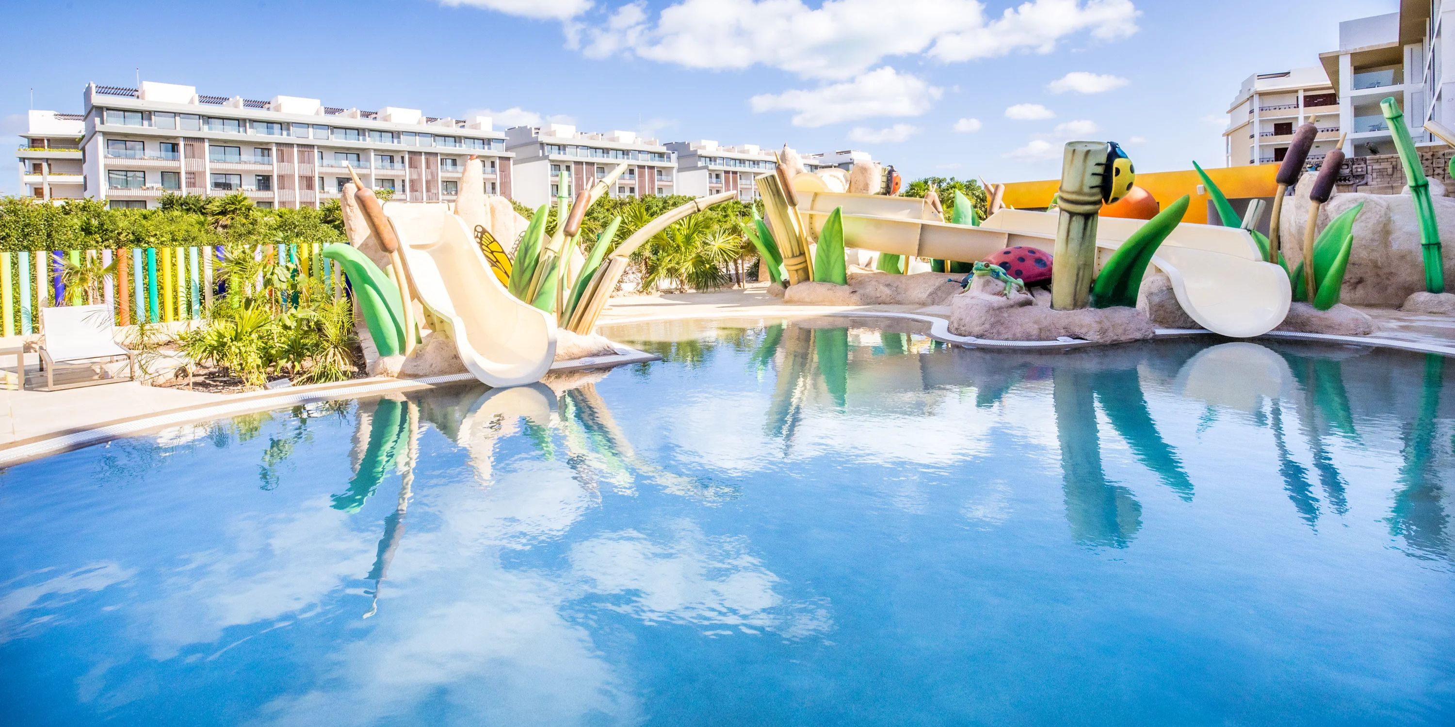 Lush pool with slides and greenery, a stunning setting for your Majestic Mirage destination wedding.