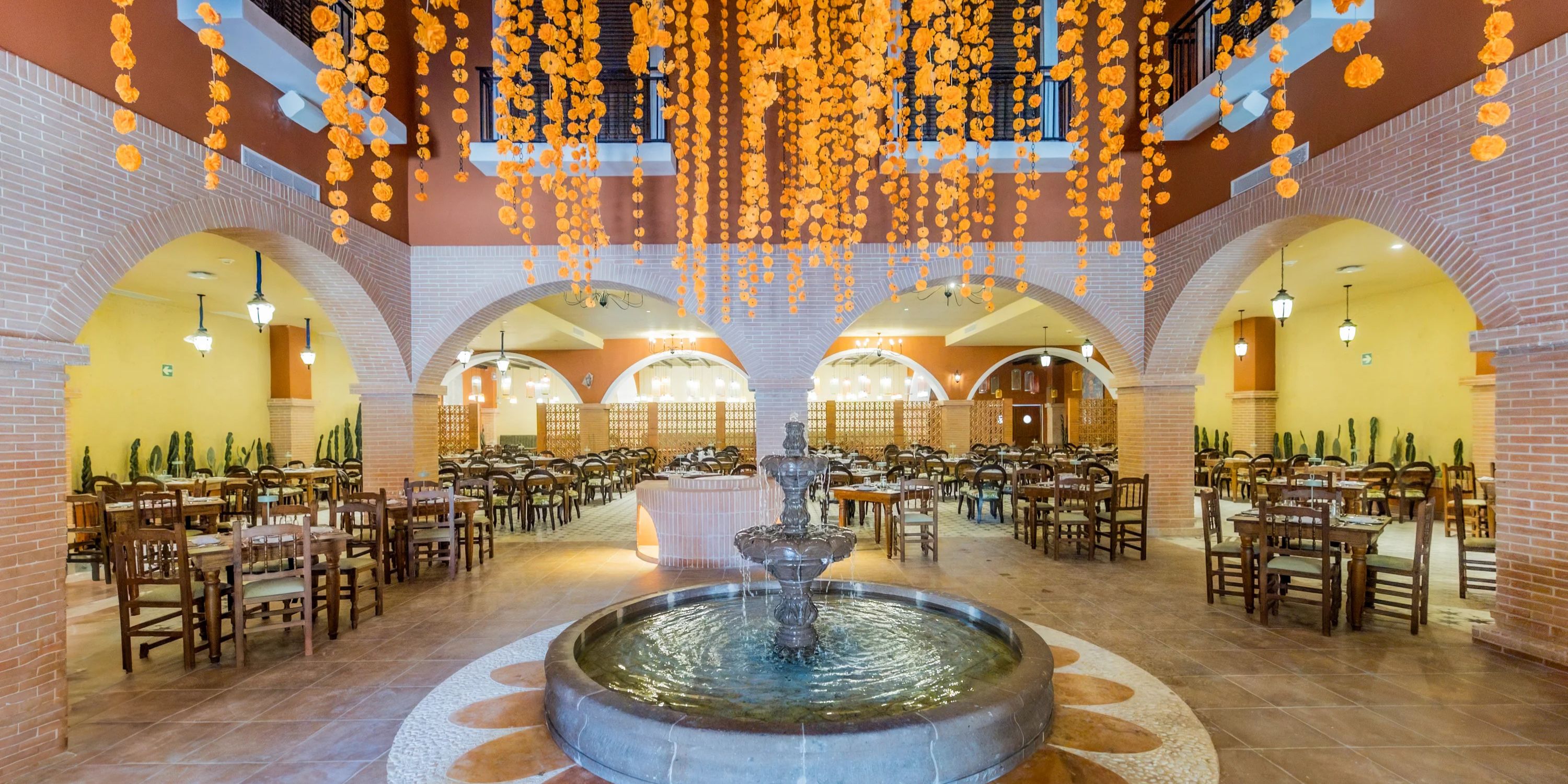 Spacious restaurant featuring a central fountain, perfect for a destination wedding at Majestic Mirage.