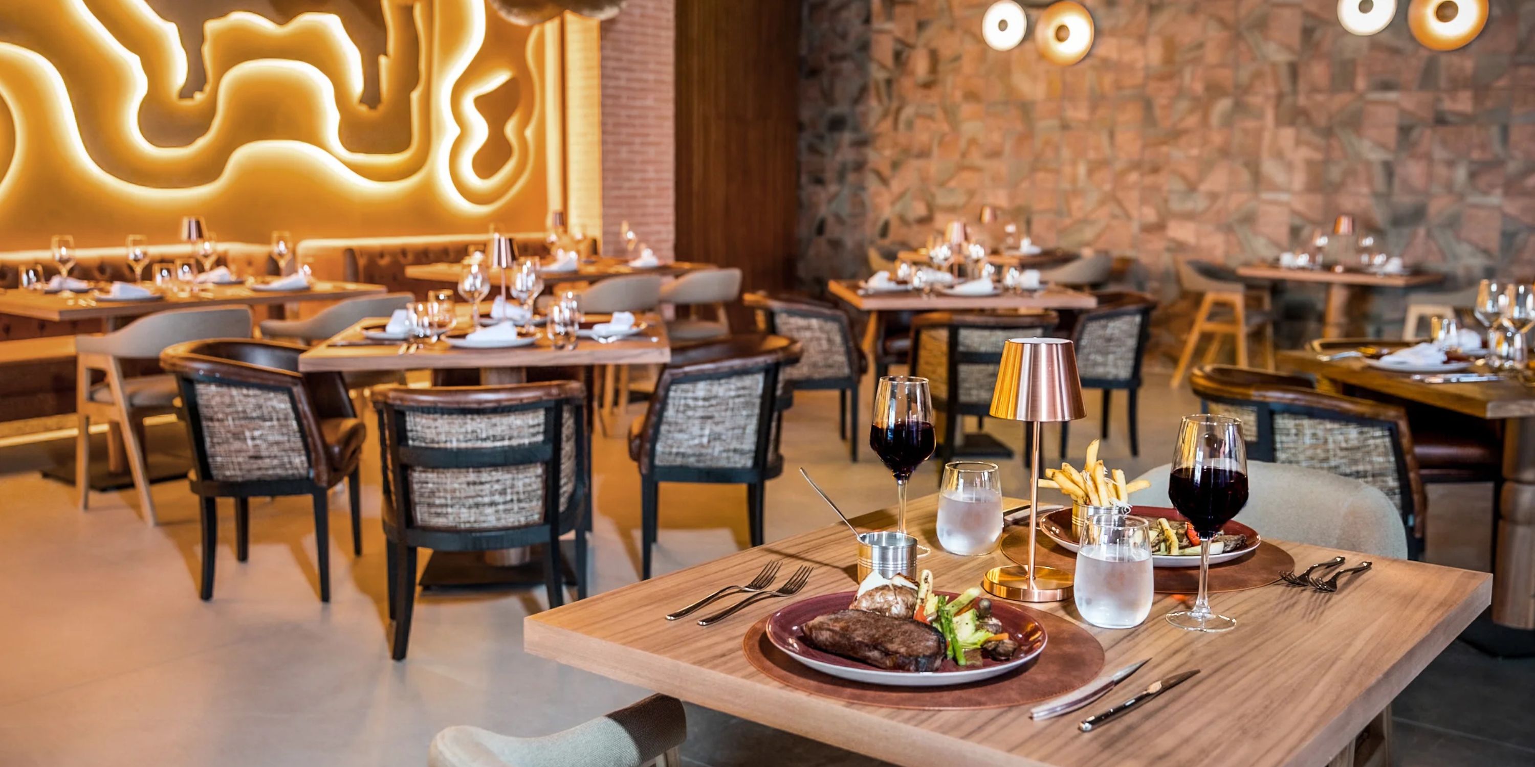Contemporary restaurant at Majestic Mirage Costa Mujeres, perfect for a destination wedding, steak served.