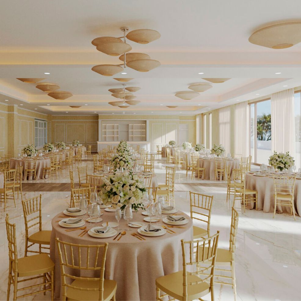 Wedding banquet hall at Majestic Mirage Costa Mujeres featuring round tables and floral centerpieces.