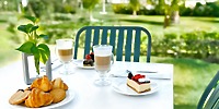 Outdoor table set with coffee, pastries, and cheesecake—an ideal treat for your Majestic Mirage Costa Mujeres destination wedding.